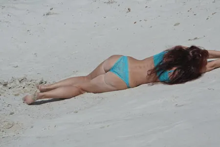 on white sand in turquos bikini         