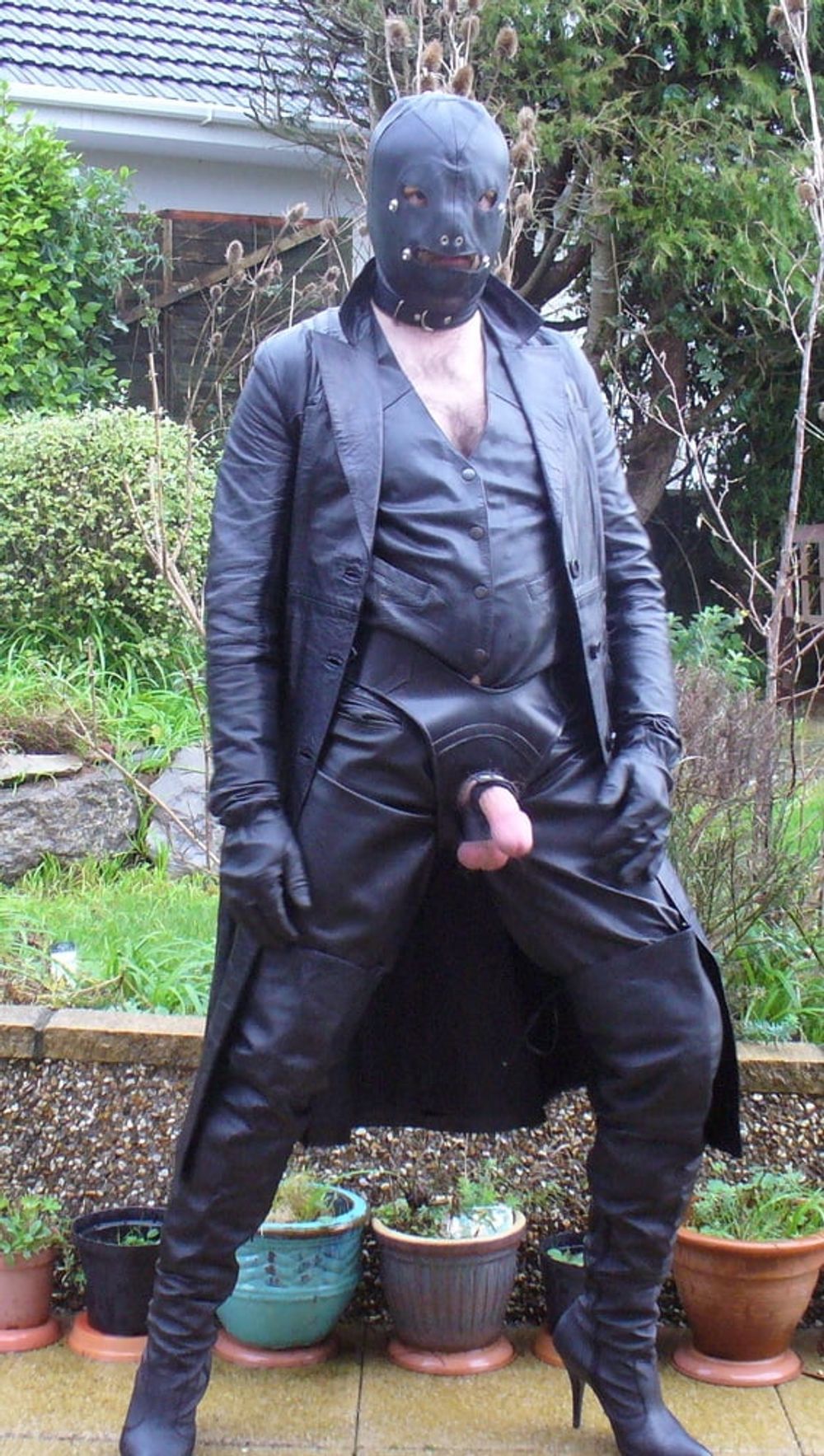 Leather Master in cock harness, boots and hood