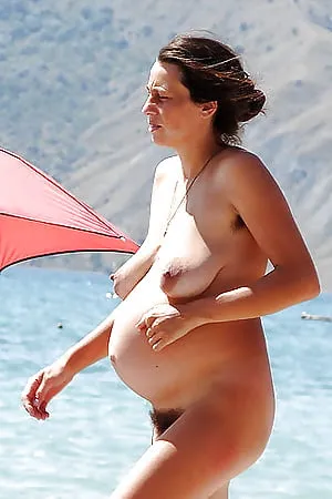 Pregnant nudist on beach        