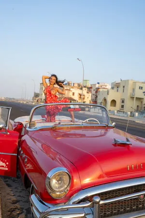 monika fox in red dress on waterfront in rare car         