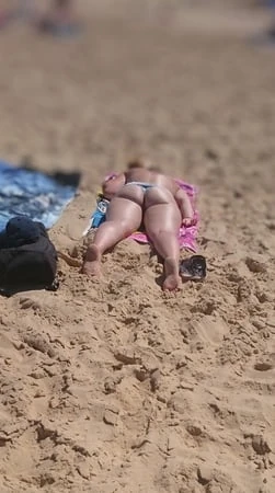 lily vdw topless on the beach with her swimsuit sticking up         