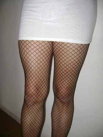 White miniskirt with fishnet stockings, in heels