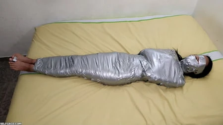 young girl duct tape wrapped like an egyptian mummy         