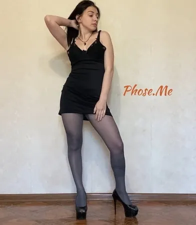 amber in black dress and grey pantyhose and high heels         