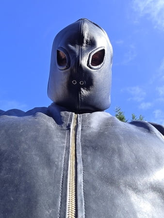 Leather gimp suit in the sun