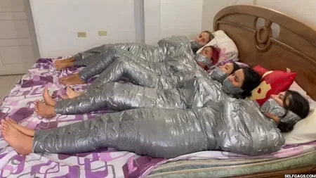   mummified girls barefoot in duct tape bondage         