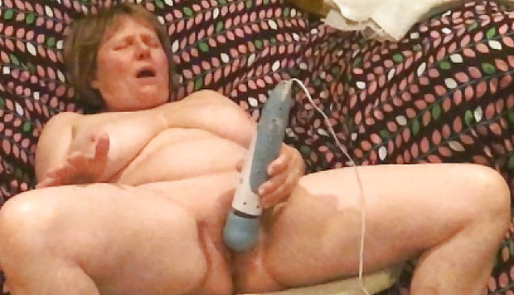 Mom plays with her vibrator in a big chair #21