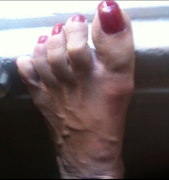 red toenails mix (older, dirty, toe ring, sandals mixed).