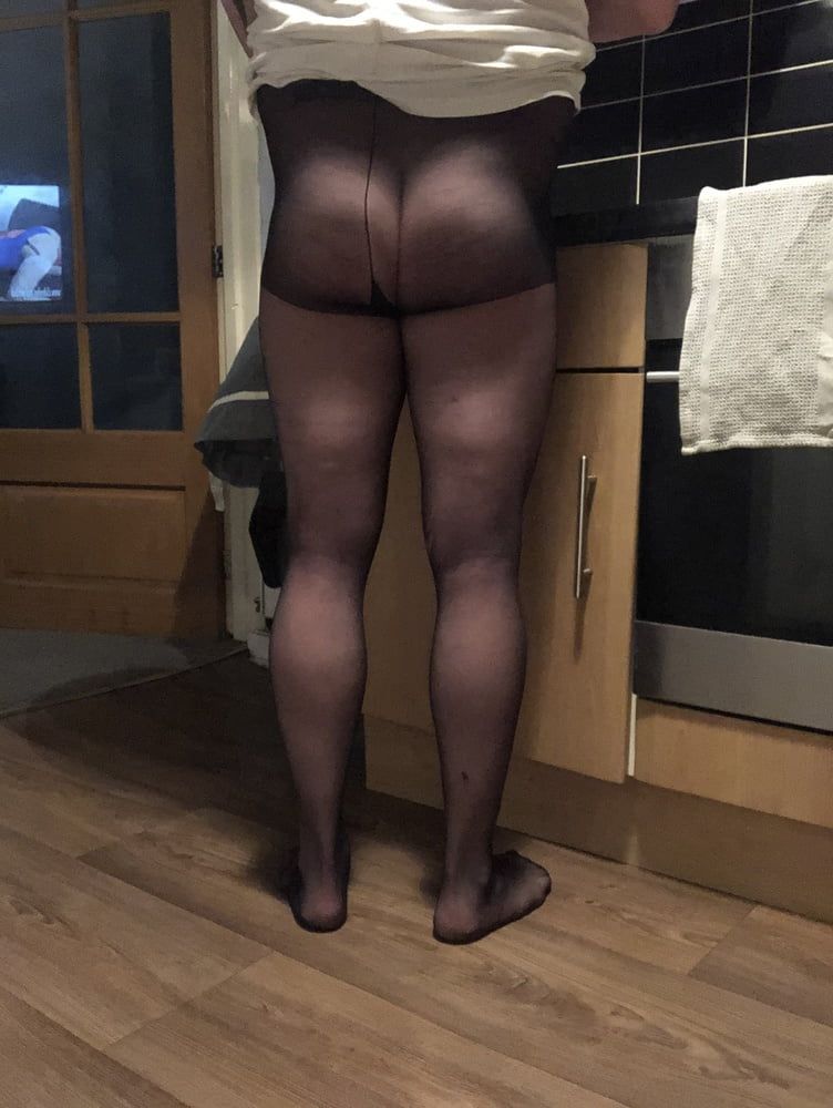 In the kitchen wearing tights 
