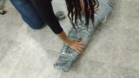 heavily duct tape mummified by crazy bondage women         