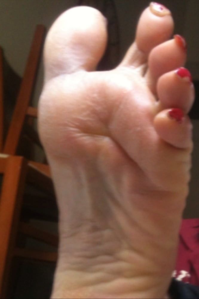 used red toenails, and soles feet after day at beach #36
