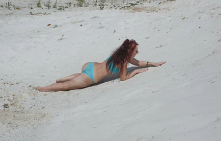 on white sand in turquos bikini         