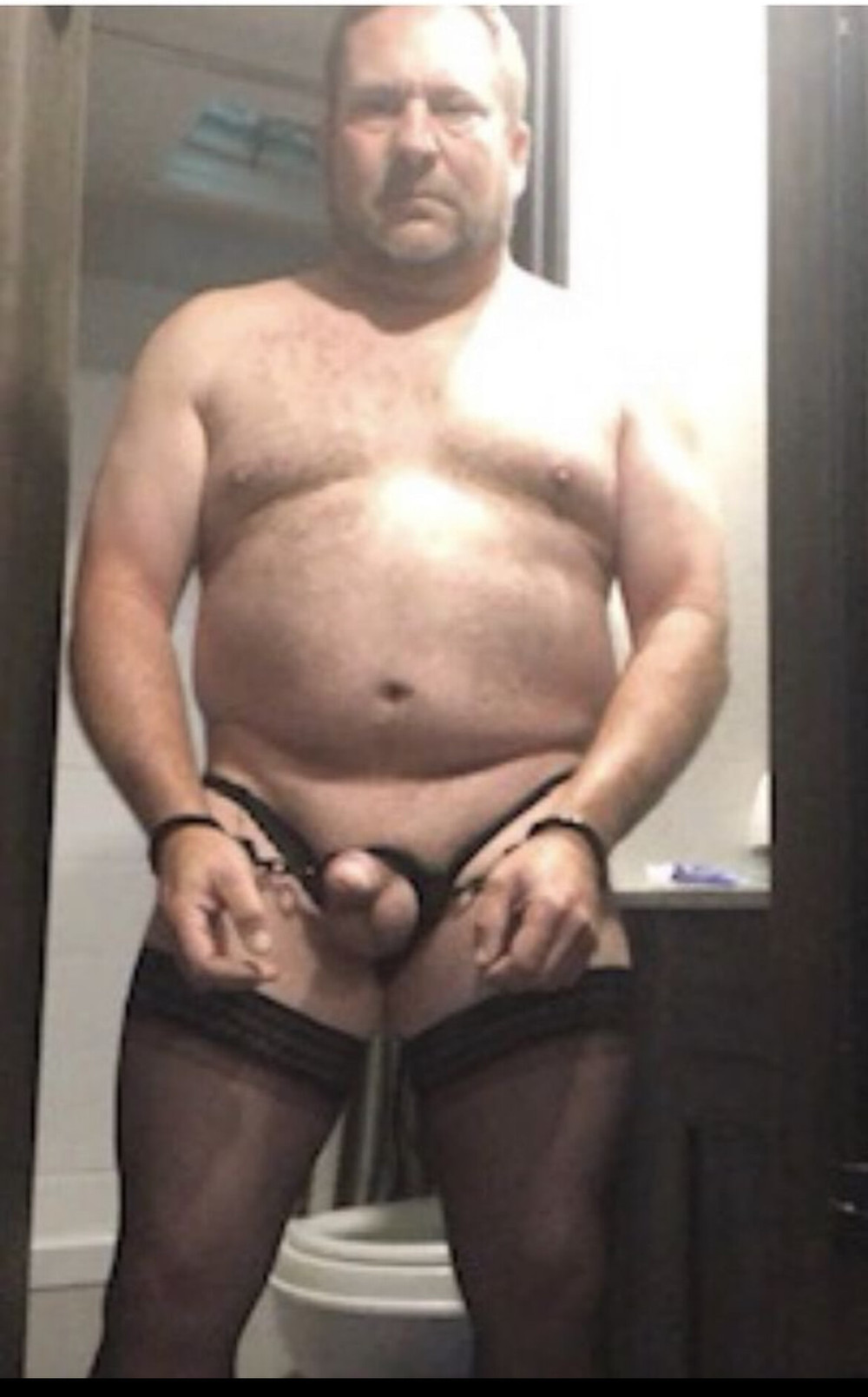 Brandon Hegsted wearing thigh highs panties and handcuffs 