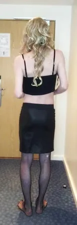 sissy crossdresser in black slut outfit posing         