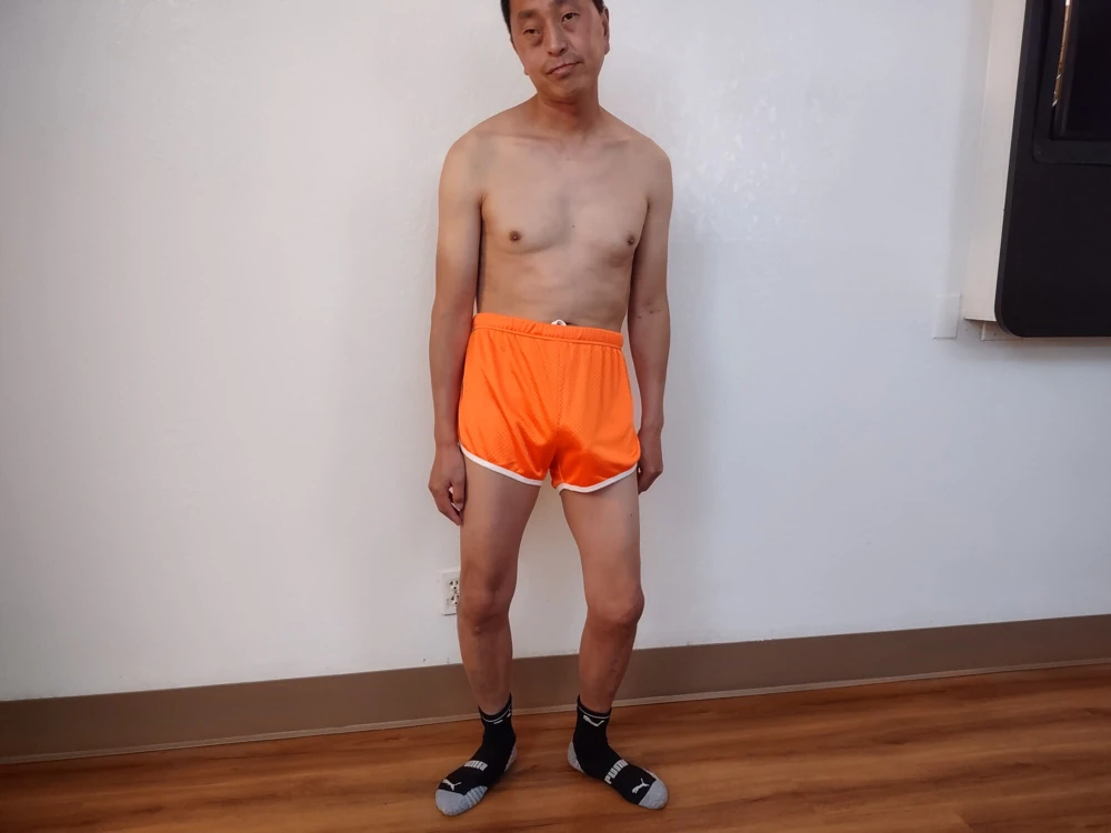 Posing in my orange retro running shorts #3