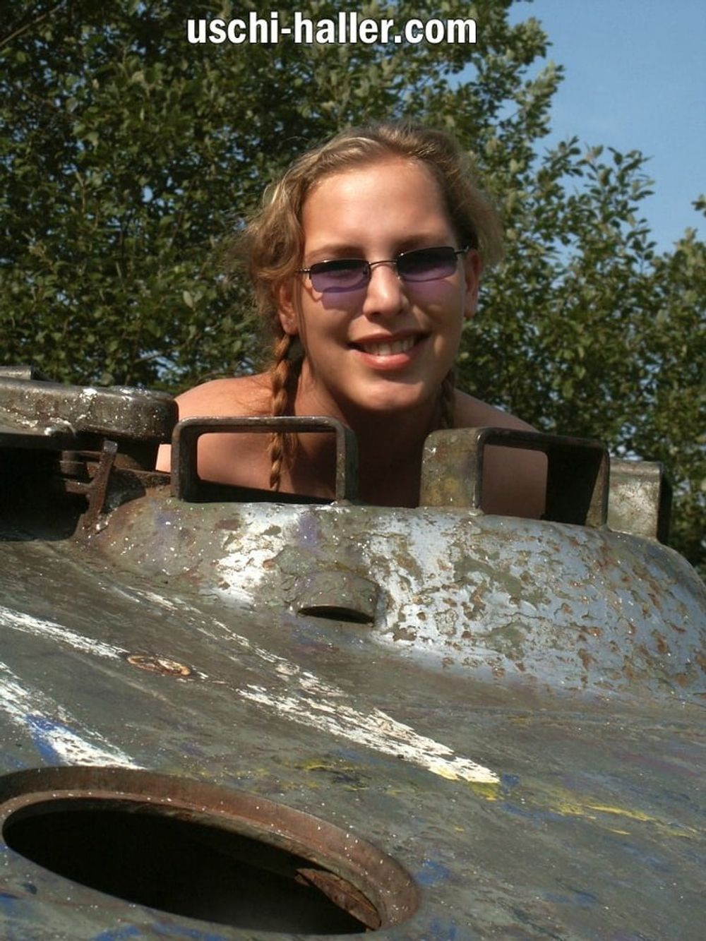 Teen Nathalie poses on an old Hotchkiss APC #52