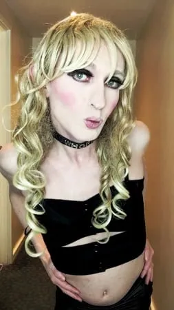 sissy crossdresser in black slut outfit posing         