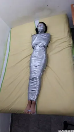 young girl duct tape wrapped like an egyptian mummy         