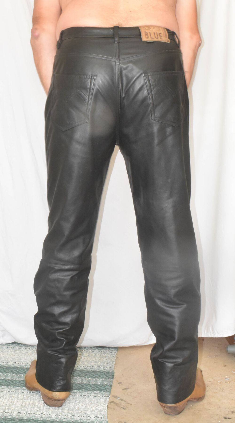 DRESSED IN A TIGHT LEATHER WITH A LEATHER PANTS. #11