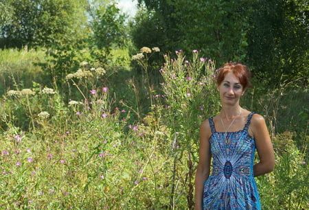 In blue dress in field