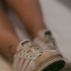 Feet in hot nylon and white Addidas sneakers