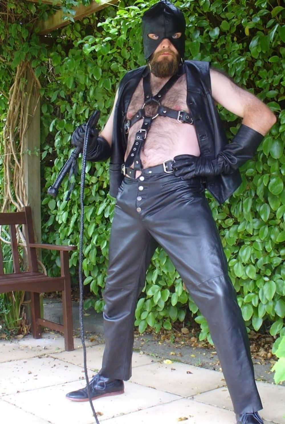 Leather Master outdoors in harness with whip #16