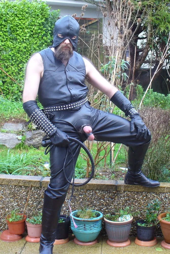 Leather Master in cock harness, boots and hood