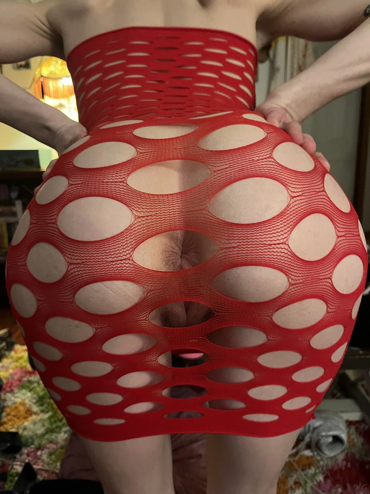 Hot slut in red fishnet dress exposes asshole
