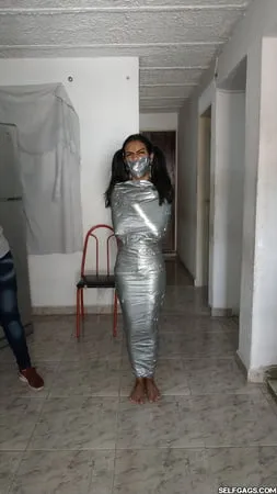 young girl duct tape wrapped like an egyptian mummy         