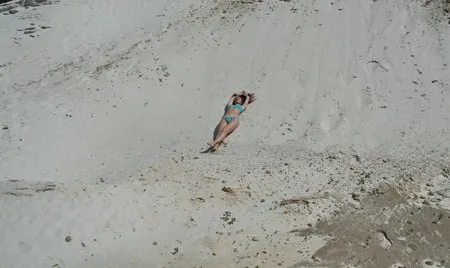 on white sand in turquos bikini         