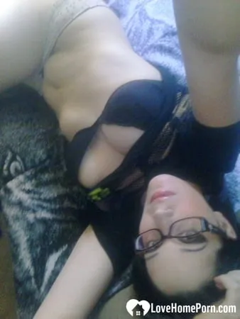 cutie with glasses sucks on a blue dildo         