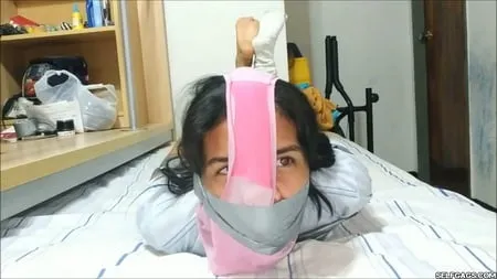 panty hooded girl gagged with socks and tape         