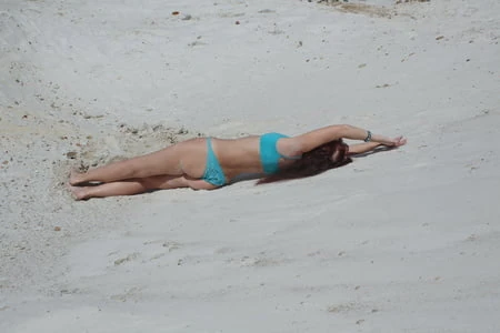 on white sand in turquos bikini         