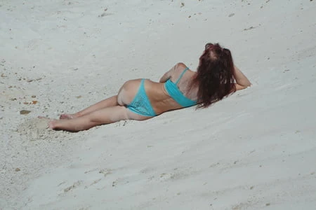 on white sand in turquos bikini         