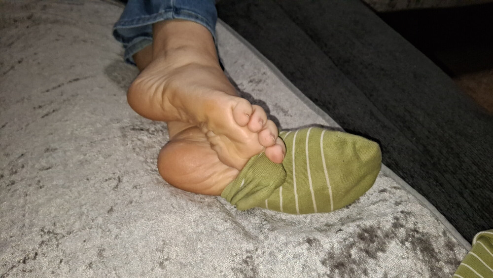 Playing with her socks and putting them back on