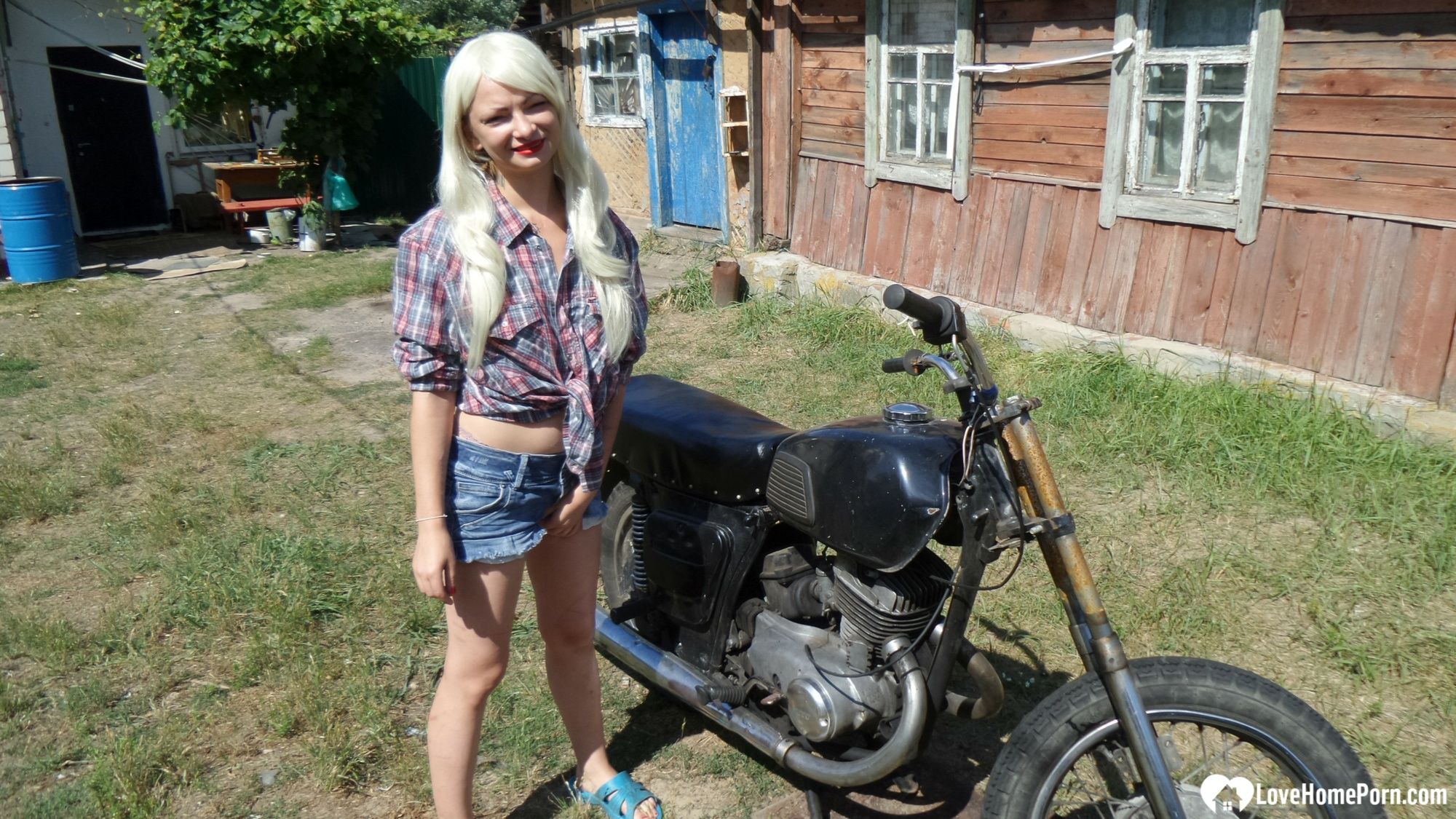 Blonde babe posing naked on a bike #2