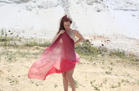 red shawl on white sand         