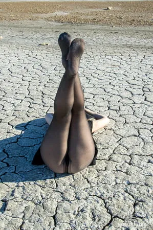 Torn and dirty feet in pantyhose outdoor