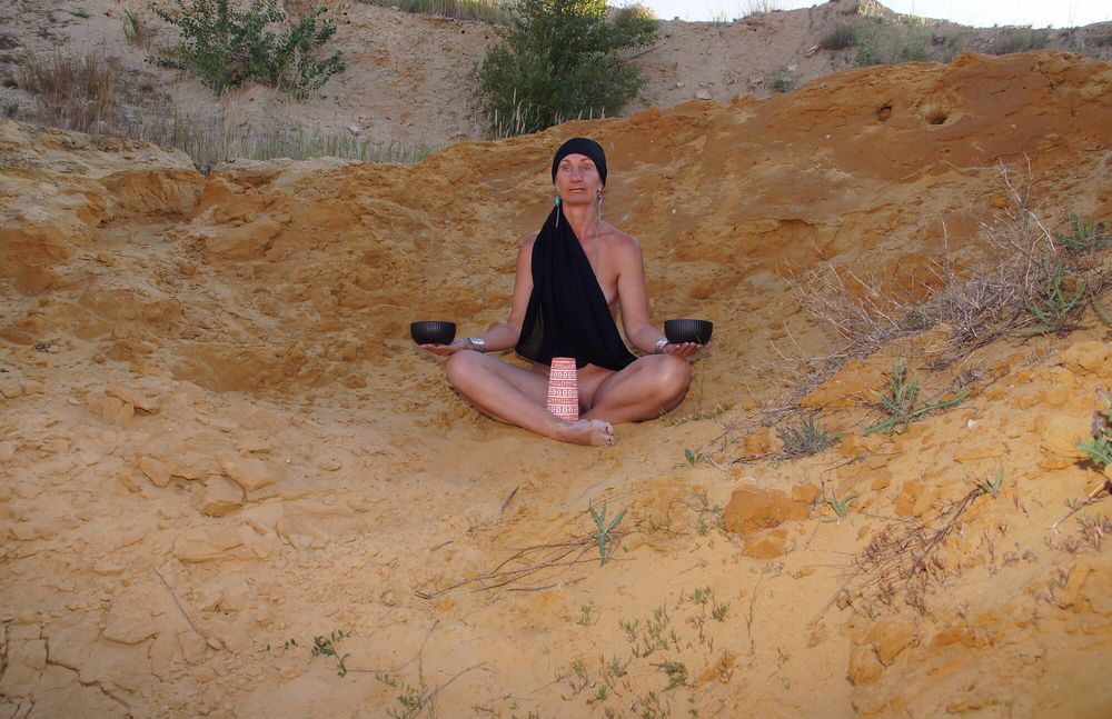 On sand seminude with light-color vase