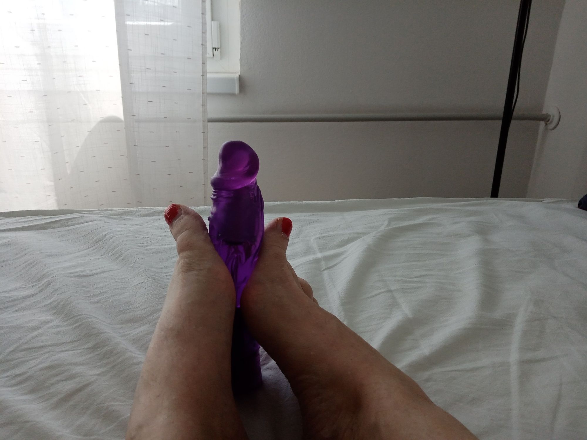 Tranny in a lying position simulates a Footjob with vibrator #5