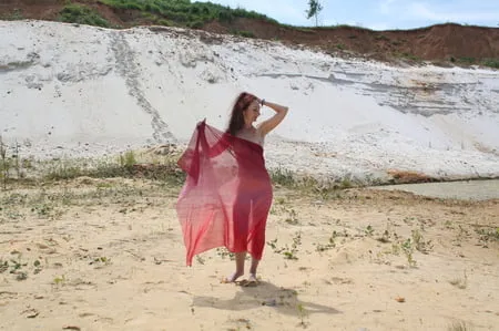 red shawl on white sand         