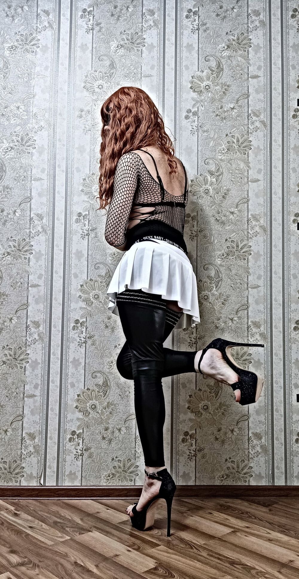 Redhead femboy poses in leather new stockings