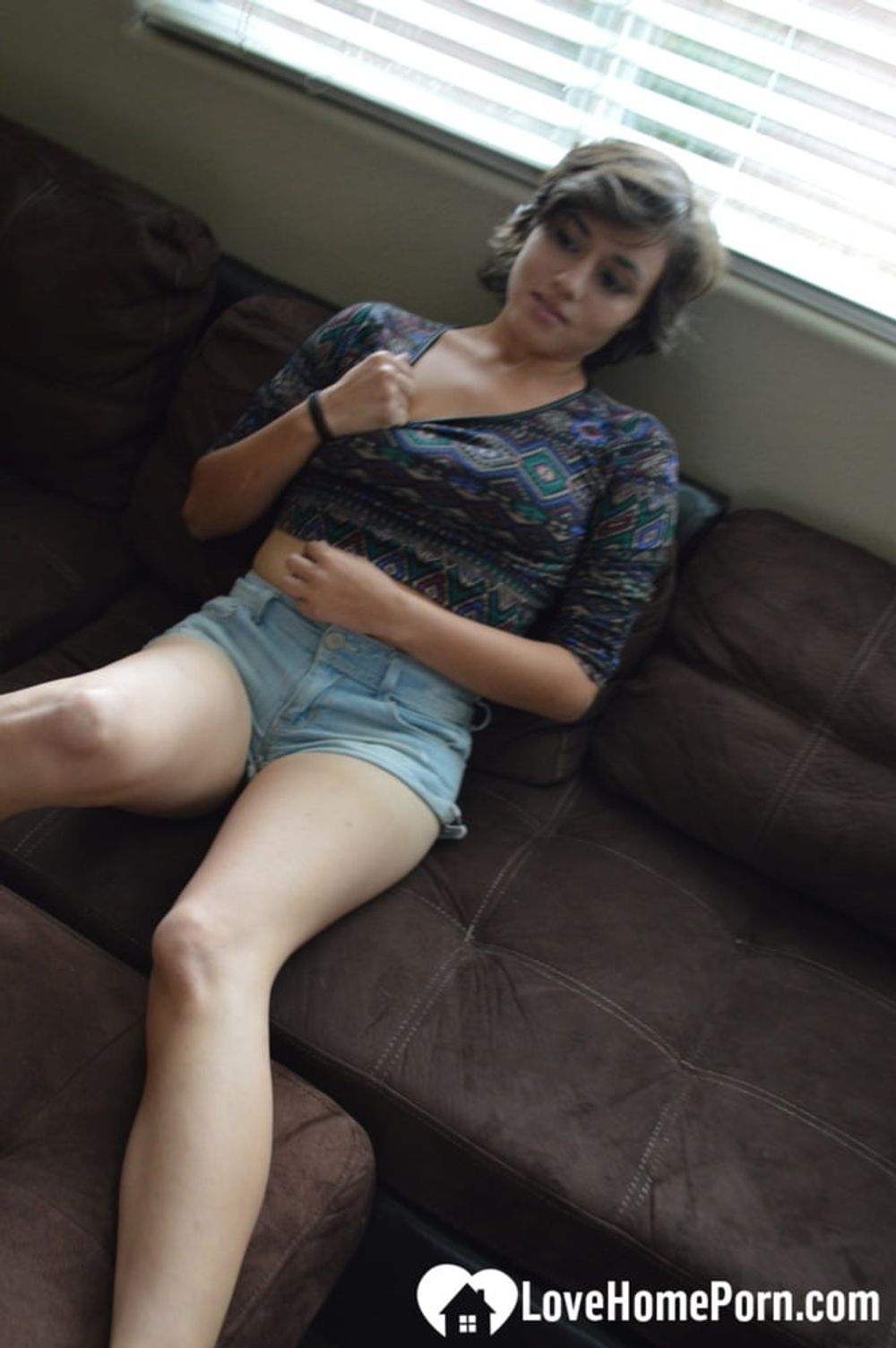 Pretty brunette satisfies herself on the couch #10