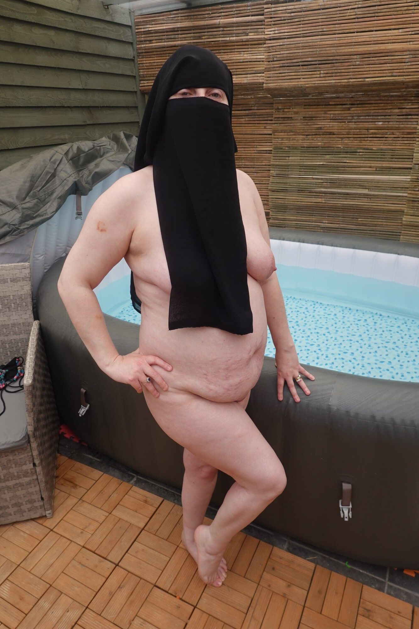 wife showing off big breasts and ass in Niqab #2