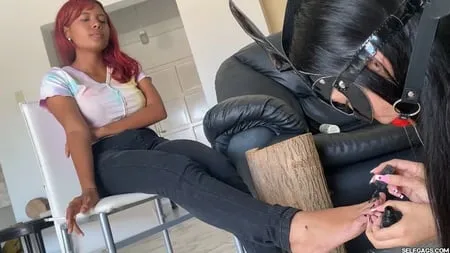 submissive slave gives mistress foot massage and pedicure         