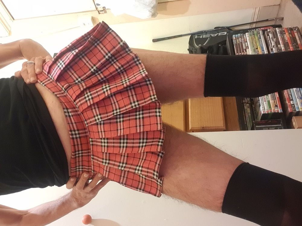 Panty boy wearing slutty schoolgirl skirt flashing pink pant