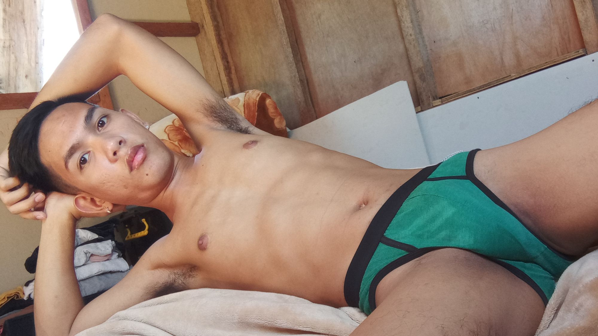 Muscled asian twink spreads his furry legs in bed #6