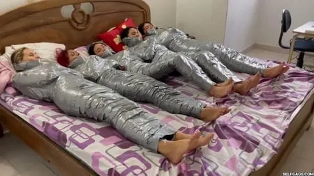   mummified girls barefoot in duct tape bondage         