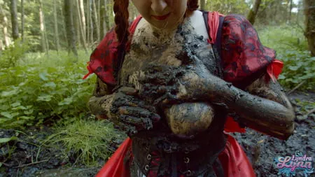 red riding hood in forest mud         