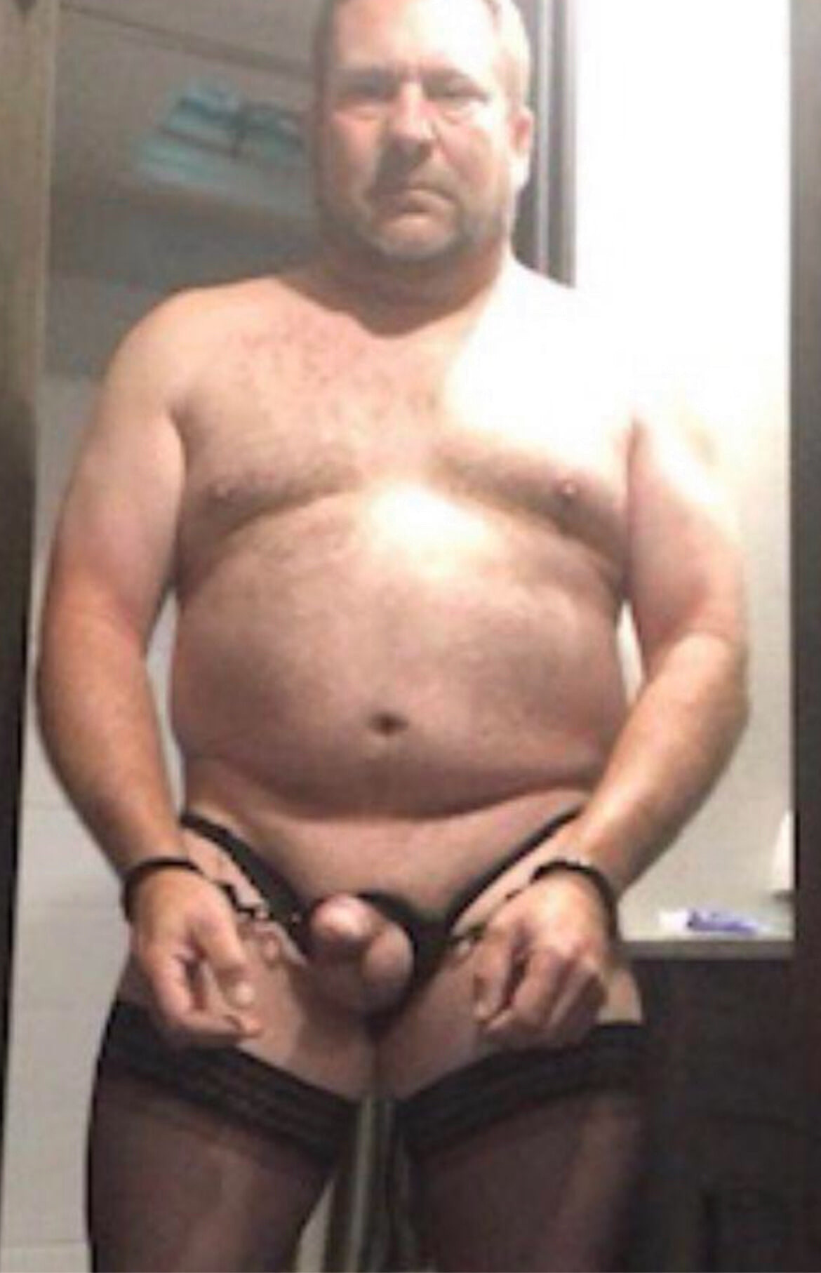 Brandon Hegsted wearing thigh thighs, panties and handcuffs 